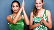 Beautiful girls making funny faces againste grey background