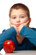 Young boy deciding to eat a healthy apple