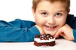 Young boy deciding to eat a dessert