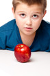 Young boy deciding to eat a healthy apple