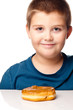 Young boy deciding to eat a donut