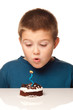 Young boy deciding to eat a dessert