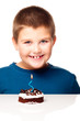 Young boy deciding to eat a dessert