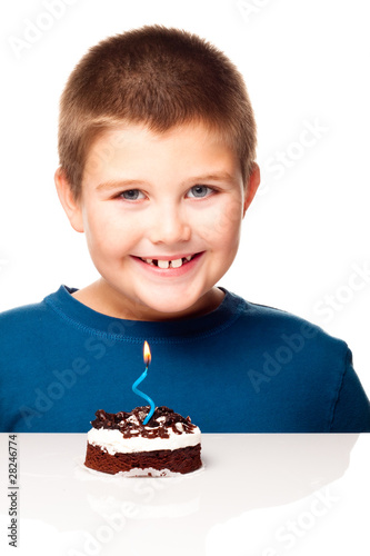 Photo: Young boy deciding to eat a dessert Young boy deciding to eat a dessert