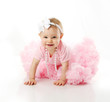 Baby girl wearing pettiskirt tutu and pearls crawling