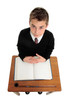 School boy sitting at school desk