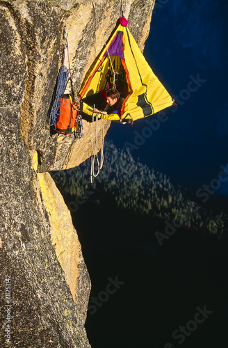 Photo: Rock climber bivouaced in a portaledge. Rock climber bivouaced in a portaledge.