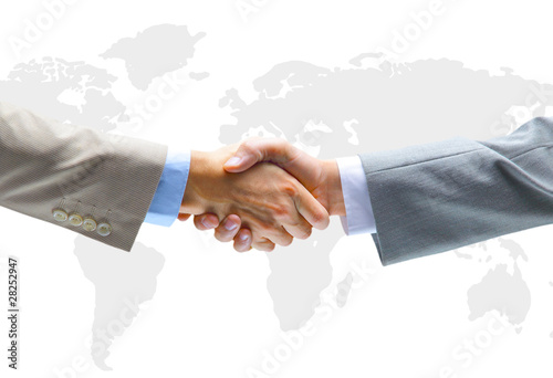Photo: Handshake with map of the world in background Handshake with map of the world in background