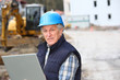 Architect with drawing on construction site Architect with drawing on construction site