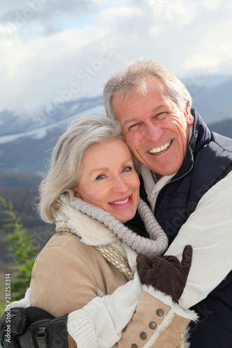 Photo: Portrait of happy senior couple at the mountain Portrait of happy senior couple at the mountain