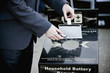 A businessman recycling household batteries