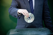 A businessman recycling a cd