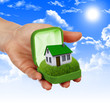 House in the hands against the blue sky House in the hands against the blue sky