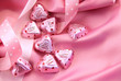 Valentine's chocolate hearts on pink satin Valentine's chocolate hearts on pink satin