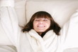 Woman falling backward onto bed