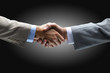 Handshake - Hand holding on black background