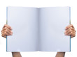 gesture of womans hand holding white magazine gesture of womans hand holding white magazine
