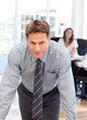 Confident man posing in front of his colleague during a meeting