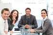 Portrait of a positive team sitting at a table