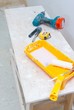 painting tools, measure tape, drill, screwdriver on white table. painting tools, measure tape, drill, screwdriver on white table.