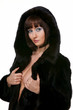 The sexy girl in a fur coat on a white background The sexy girl in a fur coat on a white background