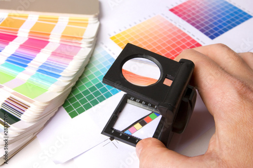 Photo: Holding a lupe and examing colours Holding a lupe and examing colours