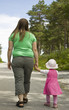 Obese mother and child walking on a forest path
