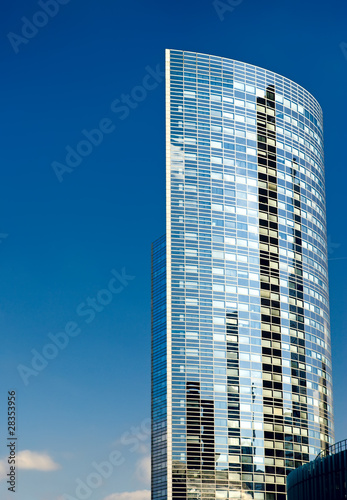 Photo: Blue modern office skyscraper on the sky.. Blue modern office skyscraper on the sky..
