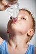 Photo : Quench thirst. The boy is drinking mineral water from bottle Quench thirst. The boy is drinking mineral water from bottle