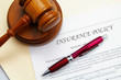 insurance policy and legal gavel with pen insurance policy and legal gavel with pen