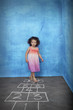Urban child playing hop scotch