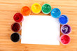 Opened paint buckets colors and paper on the table