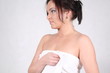 A young woman wrapped in a bath towel
