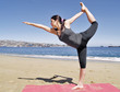 Bikram yoga dandayamana dhanurasana pose at beach Bikram yoga dandayamana dhanurasana pose at beach