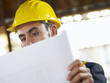 Photo: architect with blueprint in construction site architect with blueprint in construction site