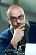 Old fashioned bald writer in glasses writing book Old fashioned bald writer in glasses writing book