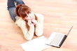 young woman with computer thinks about something