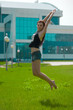 The beauty wet brunette jumps on the grass The beauty wet brunette jumps on the grass