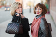 Two young women on the city street.