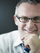 confident businessman smiling at camera