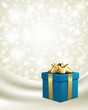 Blue gift with gold bow on silk vector background Blue gift with gold bow on silk vector background