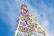 Telecommunication tower with antennas against blue sky
