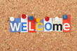 The word Welcome in magazine letters on a notice board The word Welcome in magazine letters on a notice board