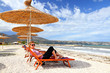girl on the beach under a parasol