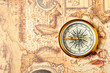 Old compass on ancient map