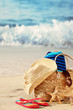 Summer beach bag on sandy beach