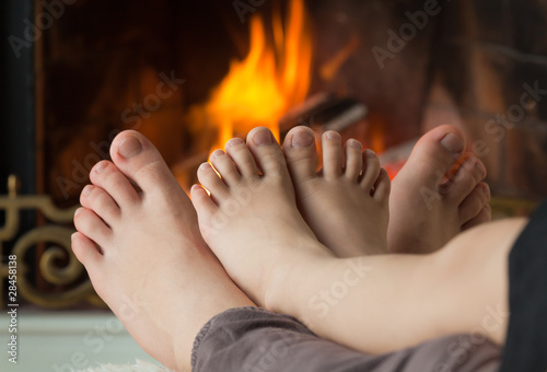 Photo: Bare legs are heated by an open fire hearth Bare legs are heated by an open fire hearth