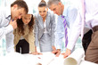Business men and women working on blue prints
