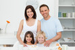 Adorable children posing with their parents in the kitchen