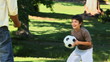 Father and son playing with a soccer ball